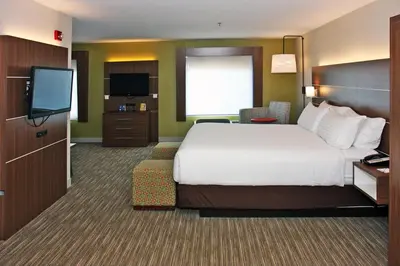 a hotel room with a bed and a flat screen tv at Holiday Inn Express Branford-New Haven by IHG in Branford