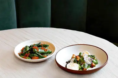 two bowls of food sitting on a table at Arlo Williamsburg in Brooklyn