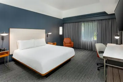 a hotel room with a bed and a desk at Courtyard by Marriott Danbury in Danbury