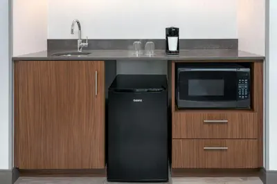 a kitchen with a black refrigerator and a microwave at Courtyard by Marriott Danbury in Danbury