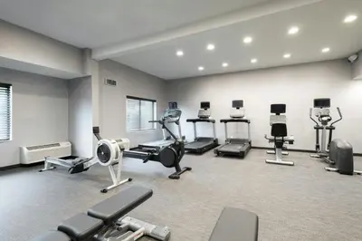 a gym with several treadmills and machines in a room at Courtyard by Marriott Danbury in Danbury