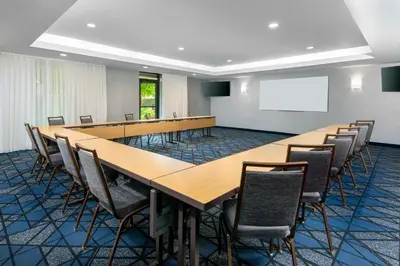 a conference room with a long table and chairs at Courtyard by Marriott Danbury in Danbury