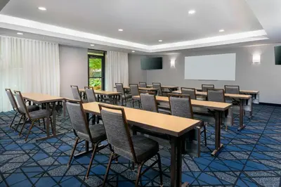 a conference room with tables and chairs and a whiteboard at Courtyard by Marriott Danbury in Danbury