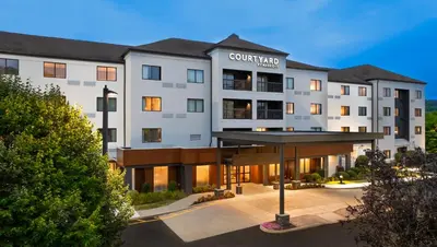 a rendering of the court yard hotel at dusk at Courtyard by Marriott Danbury in Danbury