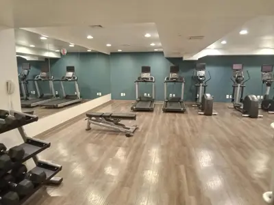 a gym with several treadmills and exercise machines at Holiday Inn Express Maspeth by IHG in Queens