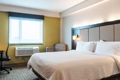 a hotel room with a bed and a window at Holiday Inn Express Maspeth by IHG in Queens