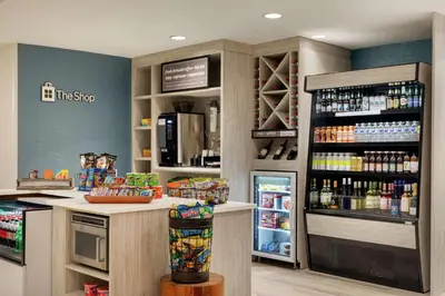 a coffee shop with a refrigerator in a store at Hilton Garden Inn Troy in Troy