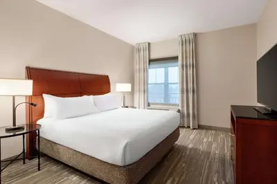 a hotel room with a large bed and a window at Hilton Garden Inn Troy in Troy