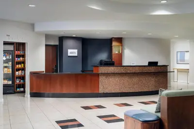 a lobby with a reception desk and a waiting room at Courtyard by Marriott Kingston in Kingston