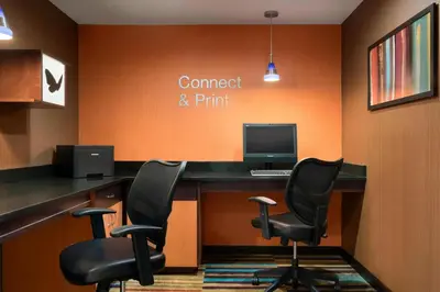 an office with a desk with two chairs and a computer at Fairfield Inn & Suites Hartford Manchester in Manchester