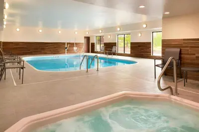 a large indoor pool with a hot tub at Fairfield Inn & Suites Hartford Manchester in Manchester
