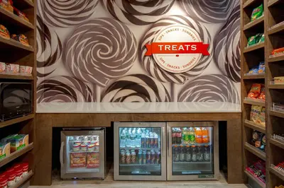 a grocery store with a treats sign on the wall at Hampton Inn & Suites Yonkers in Yonkers
