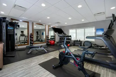 a gym with treadmills and elliptical machines at Hampton Inn & Suites Yonkers in Yonkers