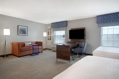 a hotel room with a bed desk and a television at Hampton Inn & Suites Yonkers in Yonkers