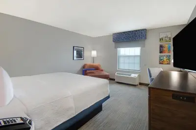 a bedroom with a bed and a flat screen tv at Hampton Inn & Suites Yonkers in Yonkers