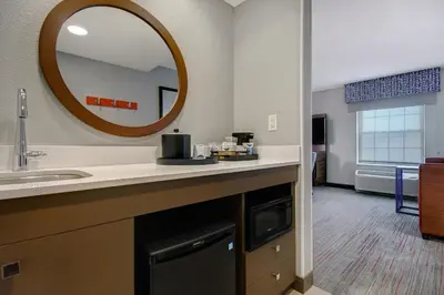 a bathroom with a sink and a mirror at Hampton Inn & Suites Yonkers in Yonkers