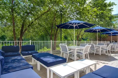 a patio with tables and chairs and umbrellas at Hampton Inn & Suites Yonkers in Yonkers