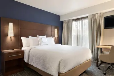 a hotel room with a large bed and a window at Residence Inn by Marriott West Springfield in West Springfield
