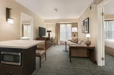 a hotel room with a bed and a living room at Residence Inn by Marriott West Springfield in West Springfield