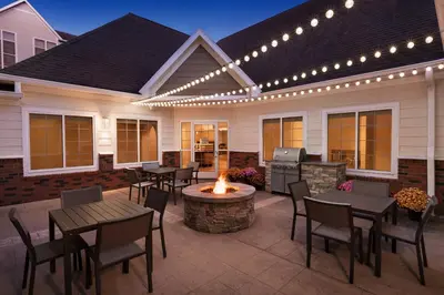 a patio with tables and chairs and a fire pit at Residence Inn by Marriott West Springfield in West Springfield