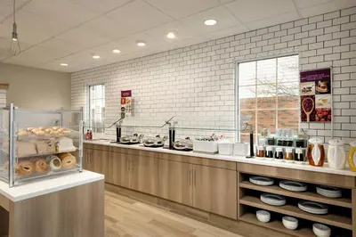 a kitchen with a counter with aasteryasteryasteryasteryasteryasteryasteryasteryastery at Residence Inn by Marriott West Springfield in West Springfield