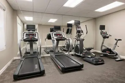 a gym with several exercise bikes and treadmills at Residence Inn by Marriott West Springfield in West Springfield
