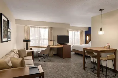 a hotel room with a bed and a living room at Residence Inn Scranton in Scranton