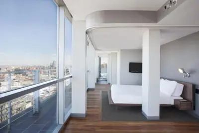 a hotel room with a bed and a balcony at Hotel on Rivington in New York