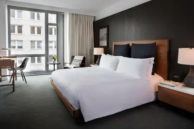 a bedroom with a large white bed and a large window at Smyth Tribeca in New York