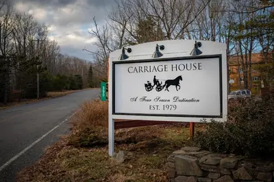 a sign for a carriage house on the side of a road at Carriage House Country Club in Pocono Manor