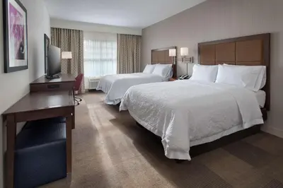 a hotel room with two beds and a television at Hampton Inn by Hilton New Paltz, NY in New Paltz