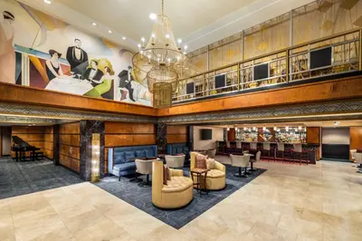 a lobby of a hotel with couches and chairs at Inn at Great Neck in Great Neck
