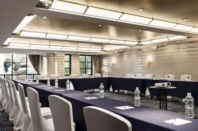 a conference room with blue tables and white chairs at Inn at Great Neck in Great Neck