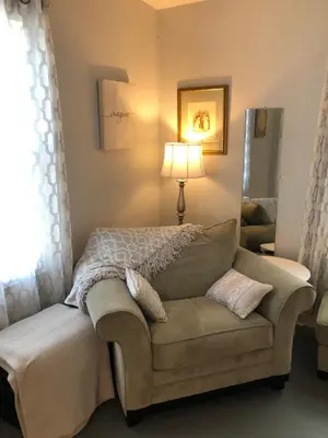 a bedroom with a bed and a couch and a lamp at Stamford Gables Bed and Breakfast in Stamford