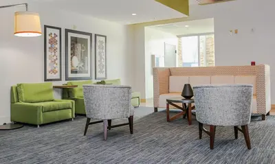 a waiting room with chairs and a table and a couch at Holiday Inn Express & Suites Kingston-Ulster by IHG in Lake Katrine
