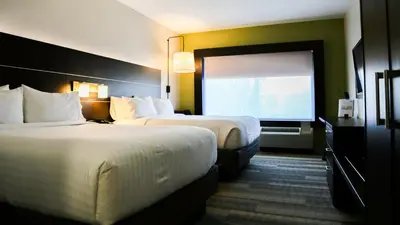 a hotel room with two beds and a large window at Holiday Inn Express & Suites Kingston-Ulster by IHG in Lake Katrine