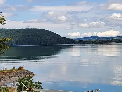 a view of a lake with mountains in the background at Lake View Motel in Cooperstown