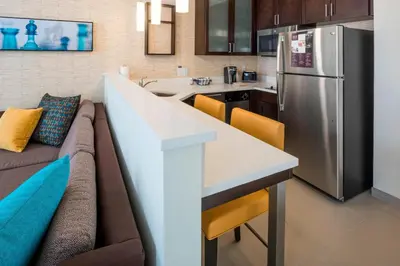 a kitchen and living room with a couch and a refrigerator at Residence Inn by Marriott Fishkill in Fishkill