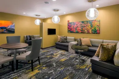 a waiting room with a couch and a table at SpringHill Suites by Marriott Fishkill in Fishkill
