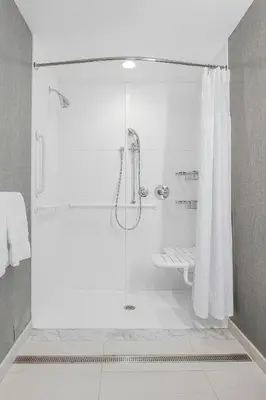 a bathroom with a shower with a glass door at SpringHill Suites by Marriott Fishkill in Fishkill