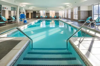 a large pool with blue water in a building at SpringHill Suites by Marriott Fishkill in Fishkill