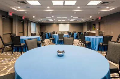 a conference room with blue tables and chairs at SpringHill Suites by Marriott Fishkill in Fishkill