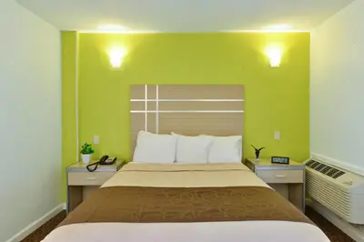 a bedroom with a large bed with green walls at Inn At Jericho in Jericho