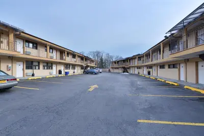 an empty parking lot in front of a building at Inn At Jericho in Jericho