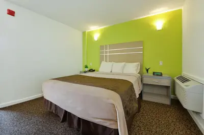 a bedroom with a large bed in a green room at Inn At Jericho in Jericho