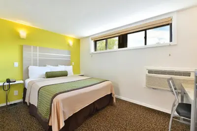 a hotel room with a bed and a window at Inn At Jericho in Jericho