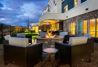 a patio with a fire pit in front of a building at Courtyard by Marriott Schenectady at Mohawk Harbor in Schenectady