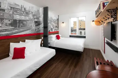 a hotel room with two beds and a couch at Hotel 1080 in Brooklyn