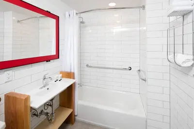 a white bathroom with a sink and a shower at Hotel 1080 in Brooklyn