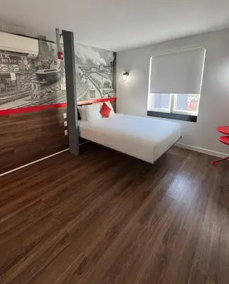 a bedroom with a bed and a painting on the wall at Hotel 1080 in Brooklyn